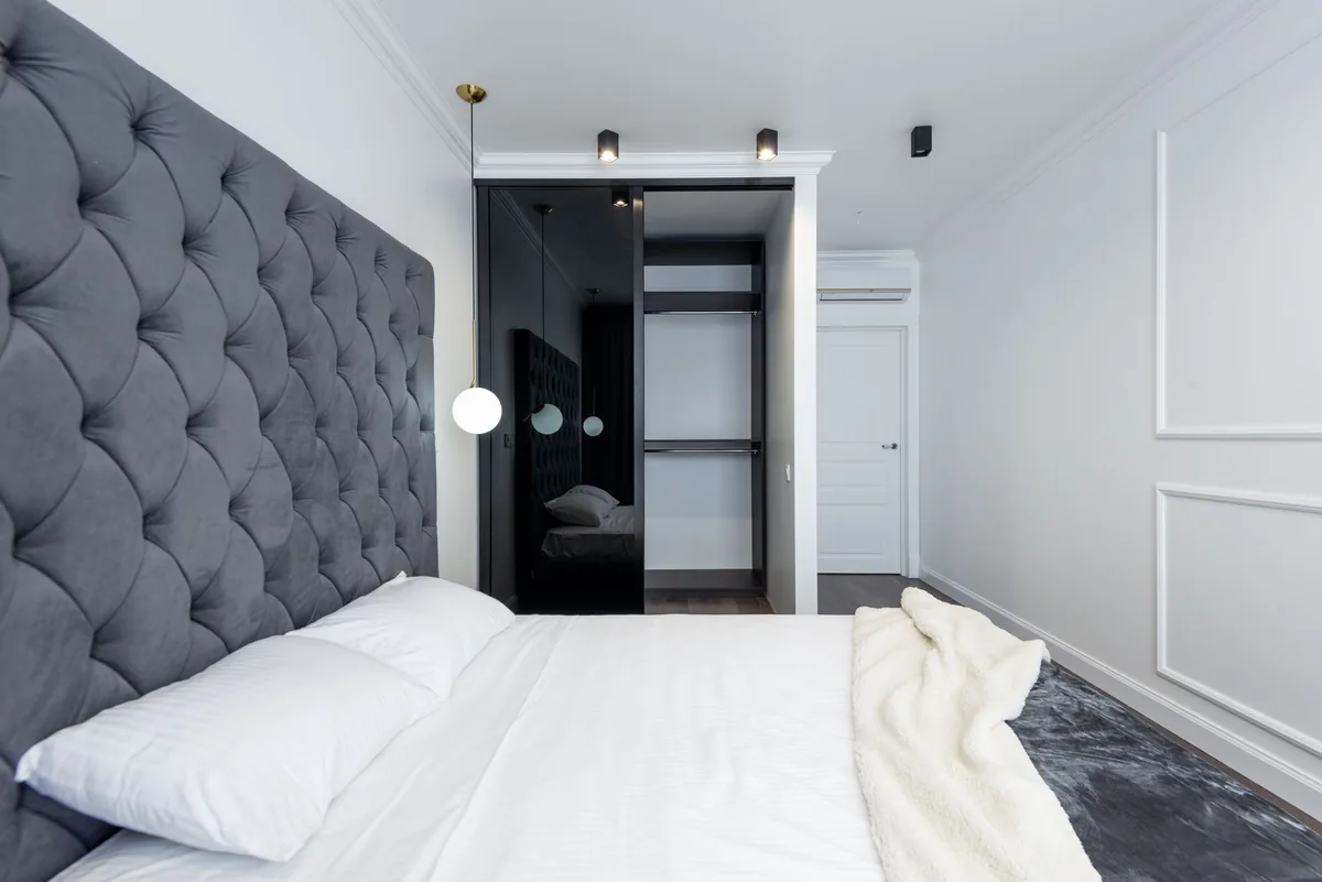 Open bedroom wardrobe where the door swing decides what can hang on it