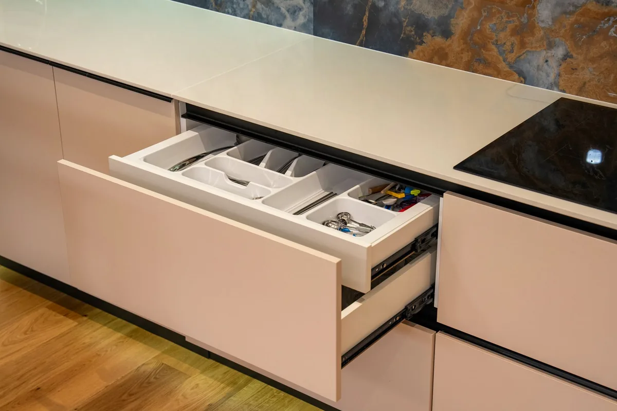 Open kitchen drawer showing the opening that must be measured, not the front